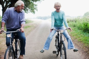 Elderly couple riding bicycle